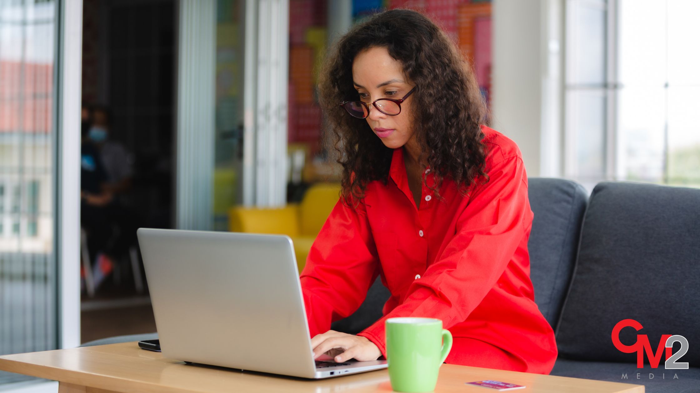 Woman in red using a laptop - AI tools for marketers.