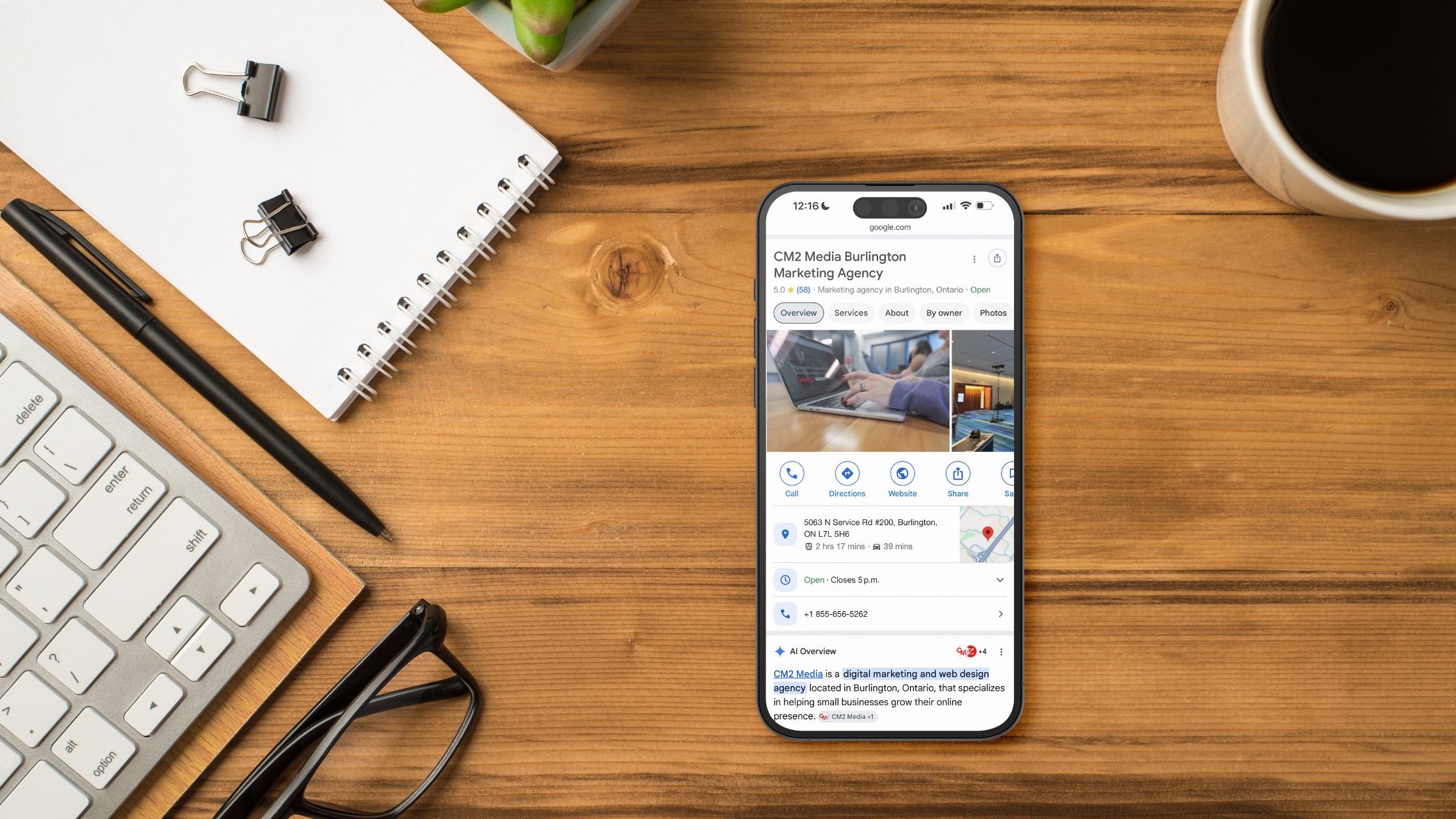 A phone on a desk showing Google Business Profile optimization - CM2 Media.