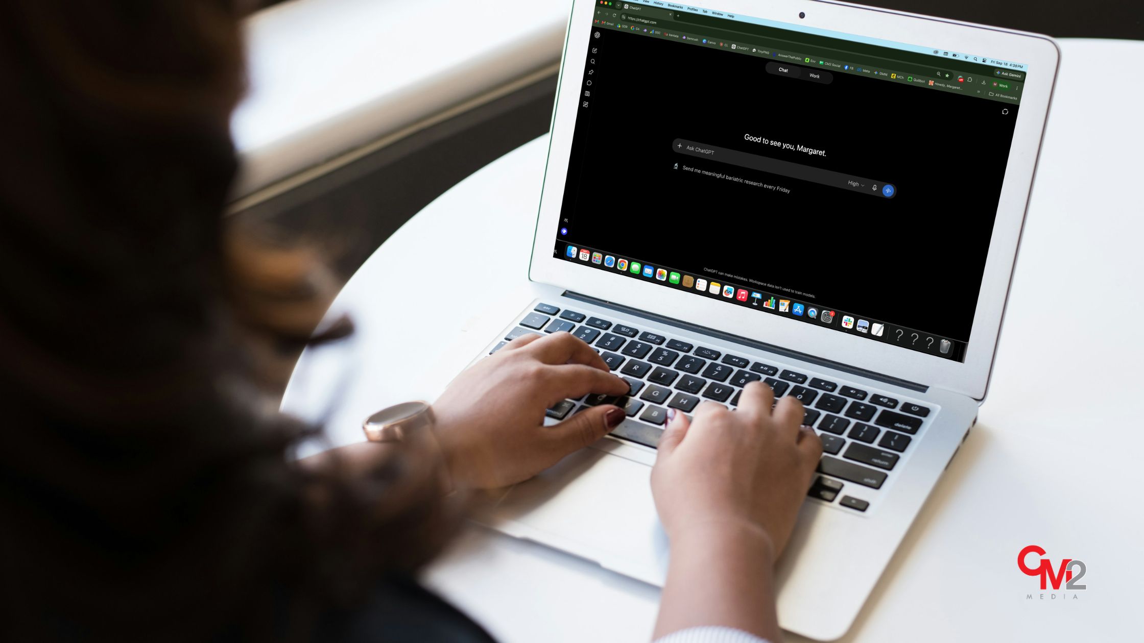 Faceless woman using a laptop and ChatGPT - how to get recommended by ChatGPT with insights from CM2 Media.