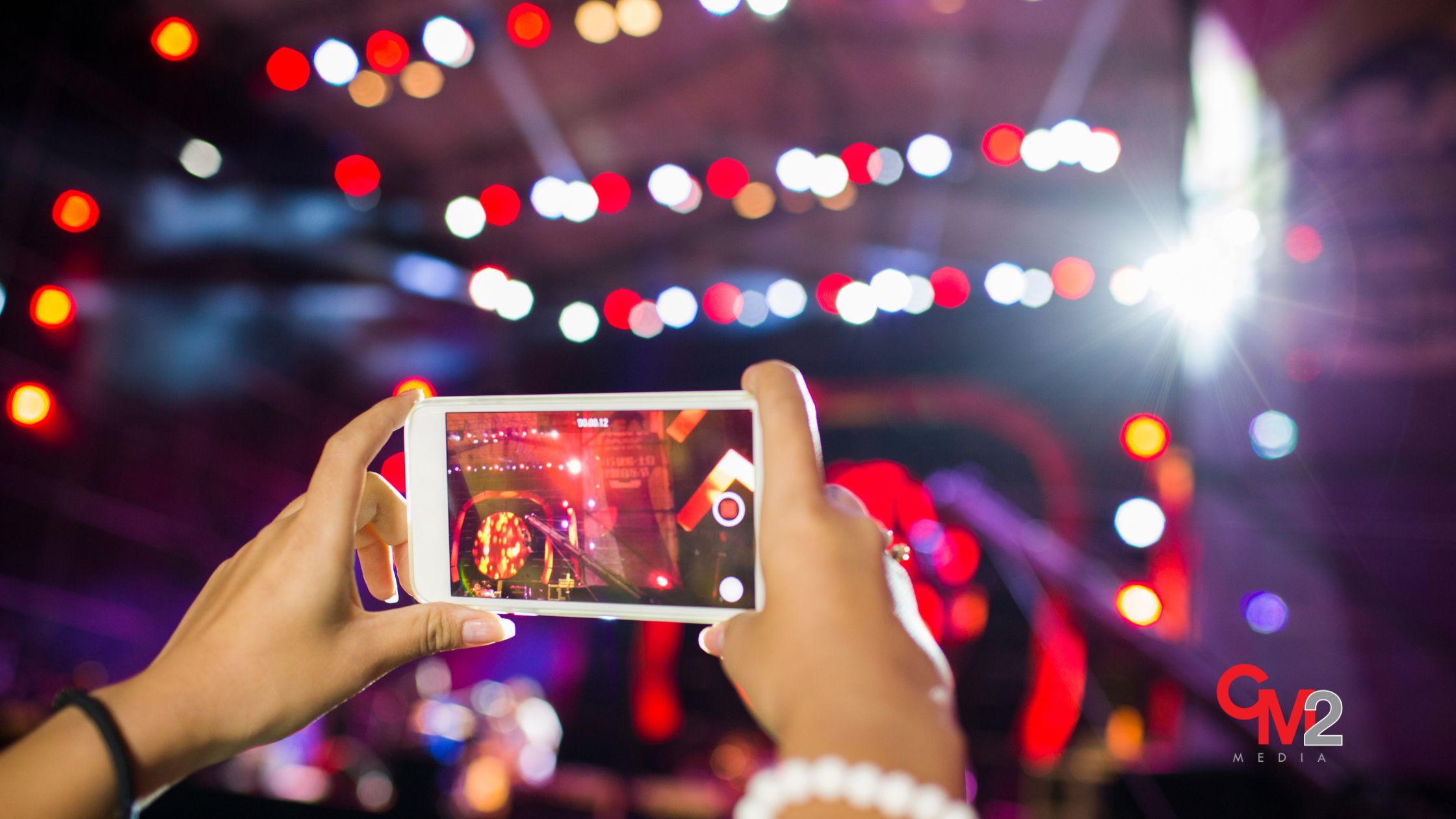 Taking a photo with a phone - CM2 Media.