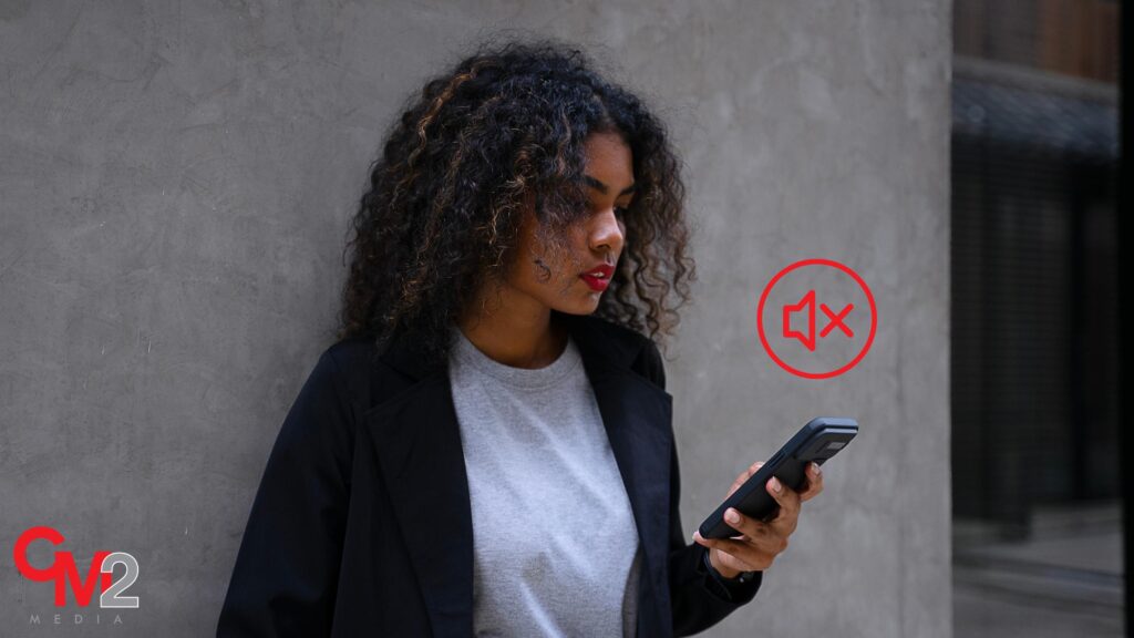 Person standing outside looking at their phone - storytelling in social media - CM2 Media.