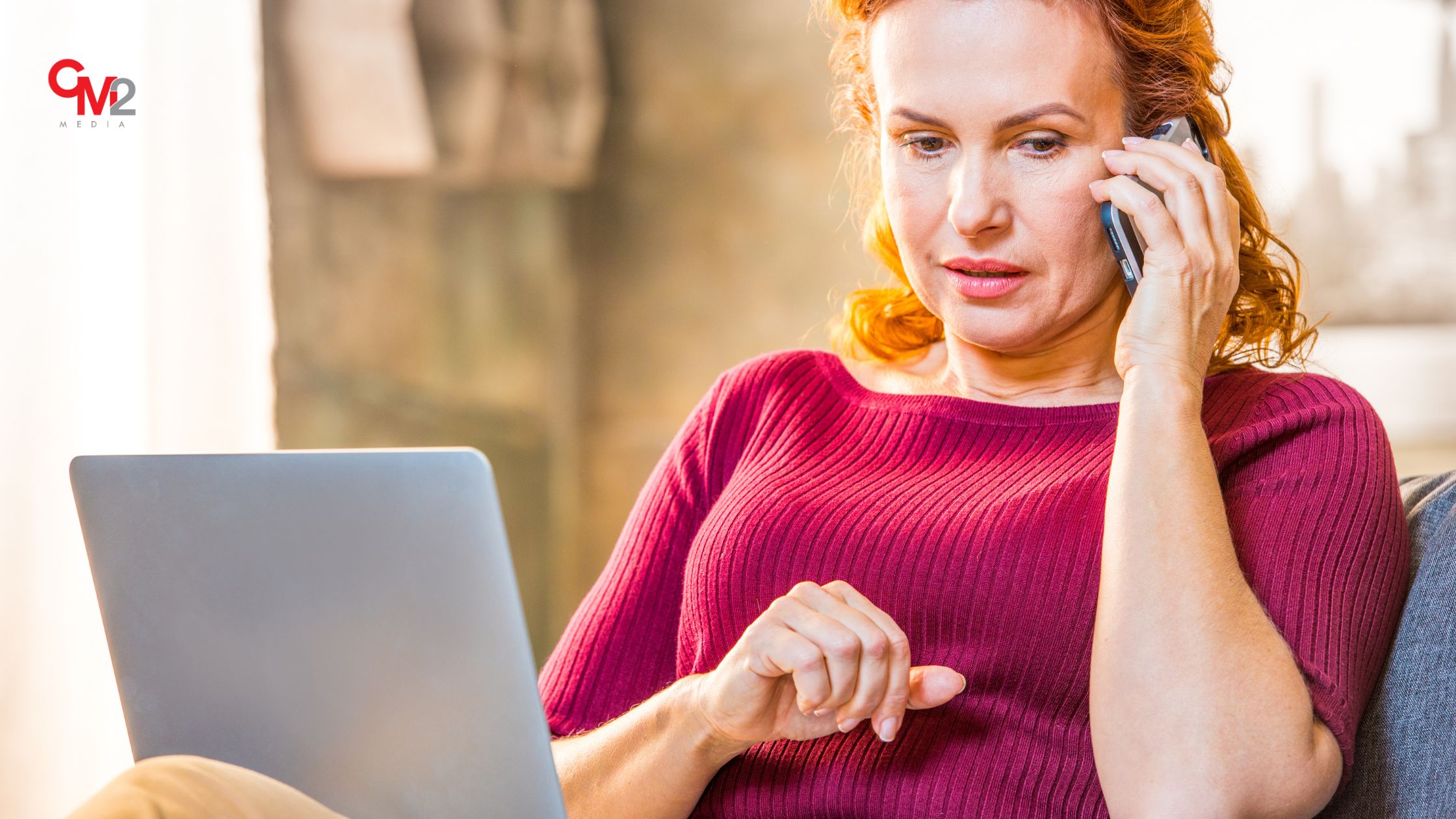 Woman using a phone and laptop - branded searches are an important new metric.
