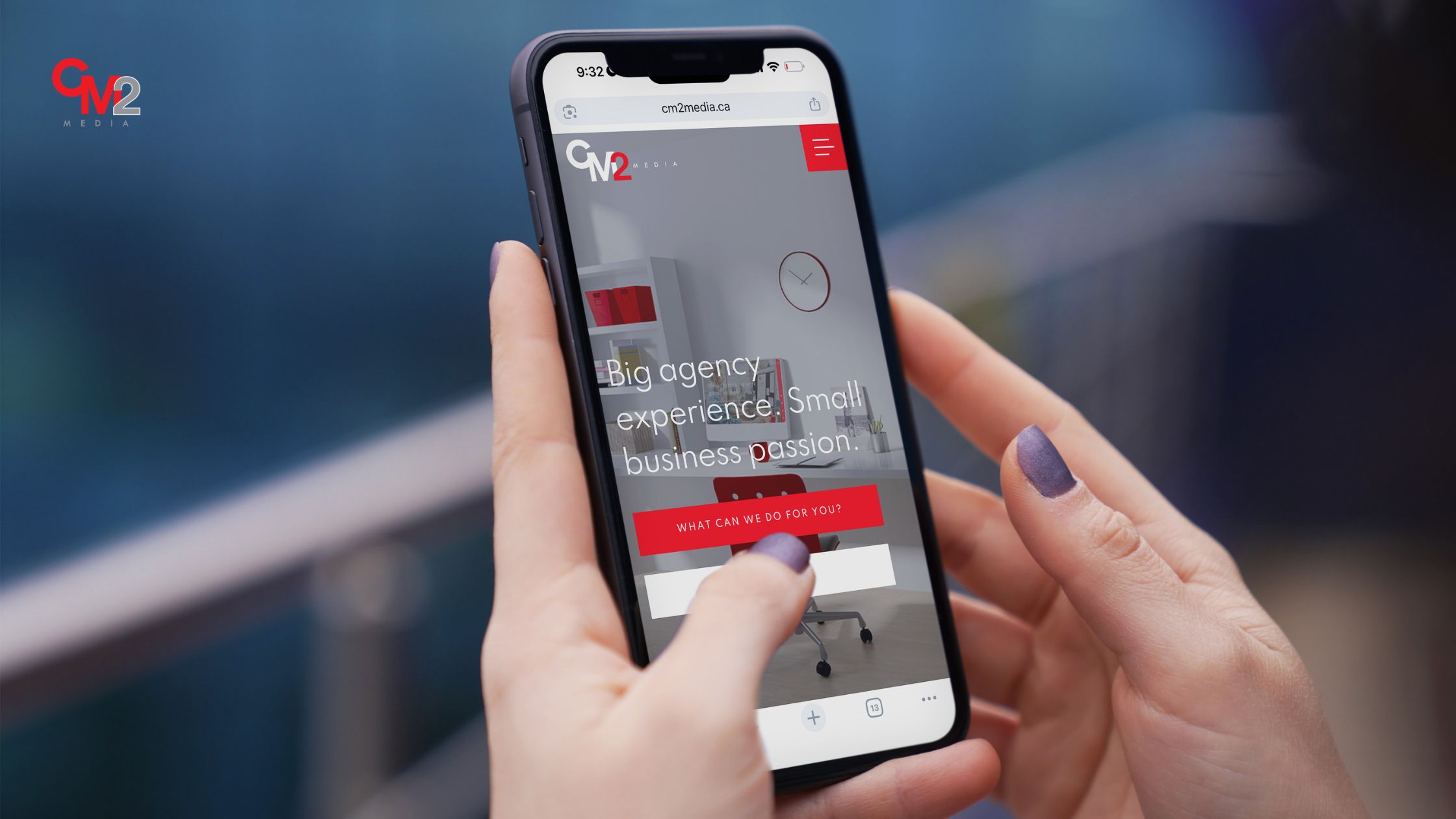 Person holding phone with CM2 Media website - brand messaging tips.